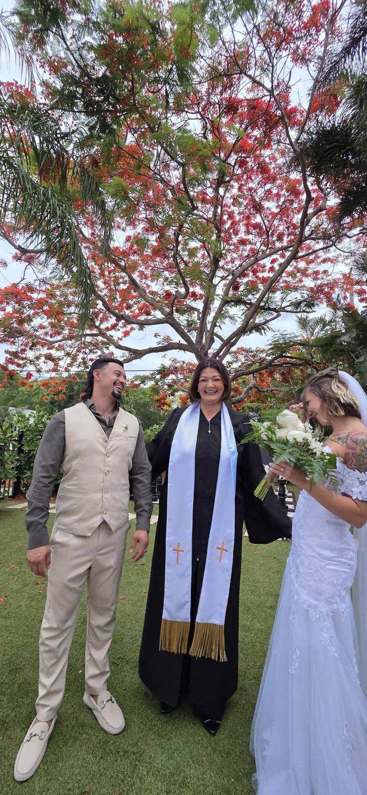 Couple exchanging vows beneath a blossoming cherry tree